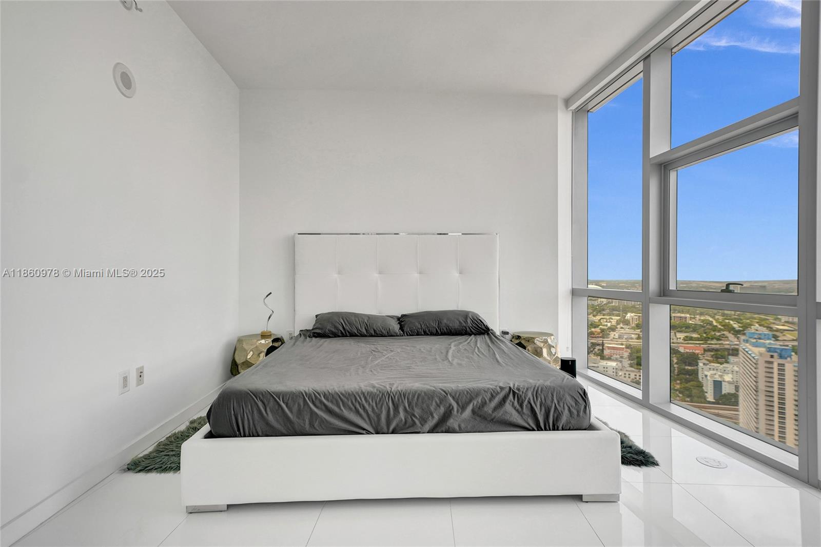 851 Northeast 1st Avenue, Unit 3800 Miami, FL 33132 - Photo 22 of 29 a bedroom with a large bed and a large window