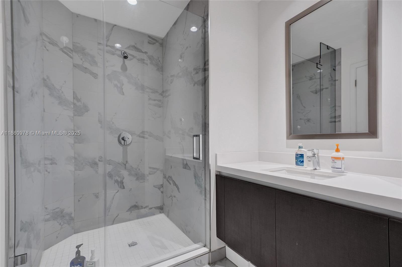 851 Northeast 1st Avenue, Unit 3800 Miami, FL 33132 - Photo 29 of 29 a bathroom with a sink and a mirror