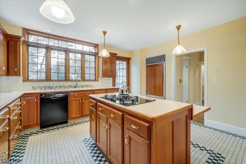 a kitchen that has a stove and a table in it