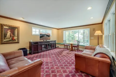 a living room with furniture and large windows
