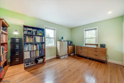 a room with lounge chair and wooden floor