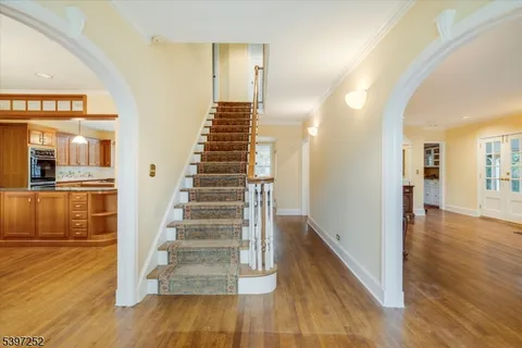 a view of a hallway with wooden floor and entryway