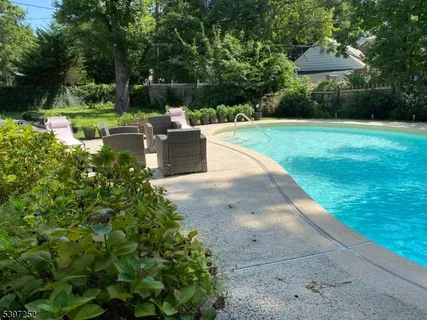 a view of a backyard with sitting area