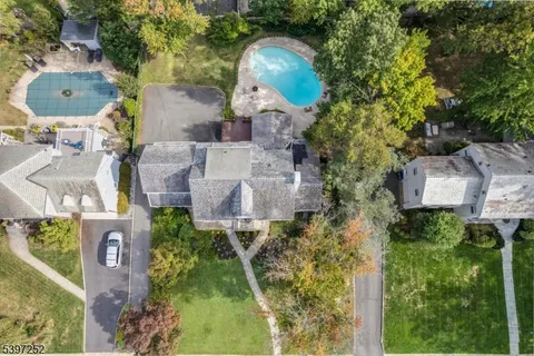 an aerial view of a house with garden space and a fountain
