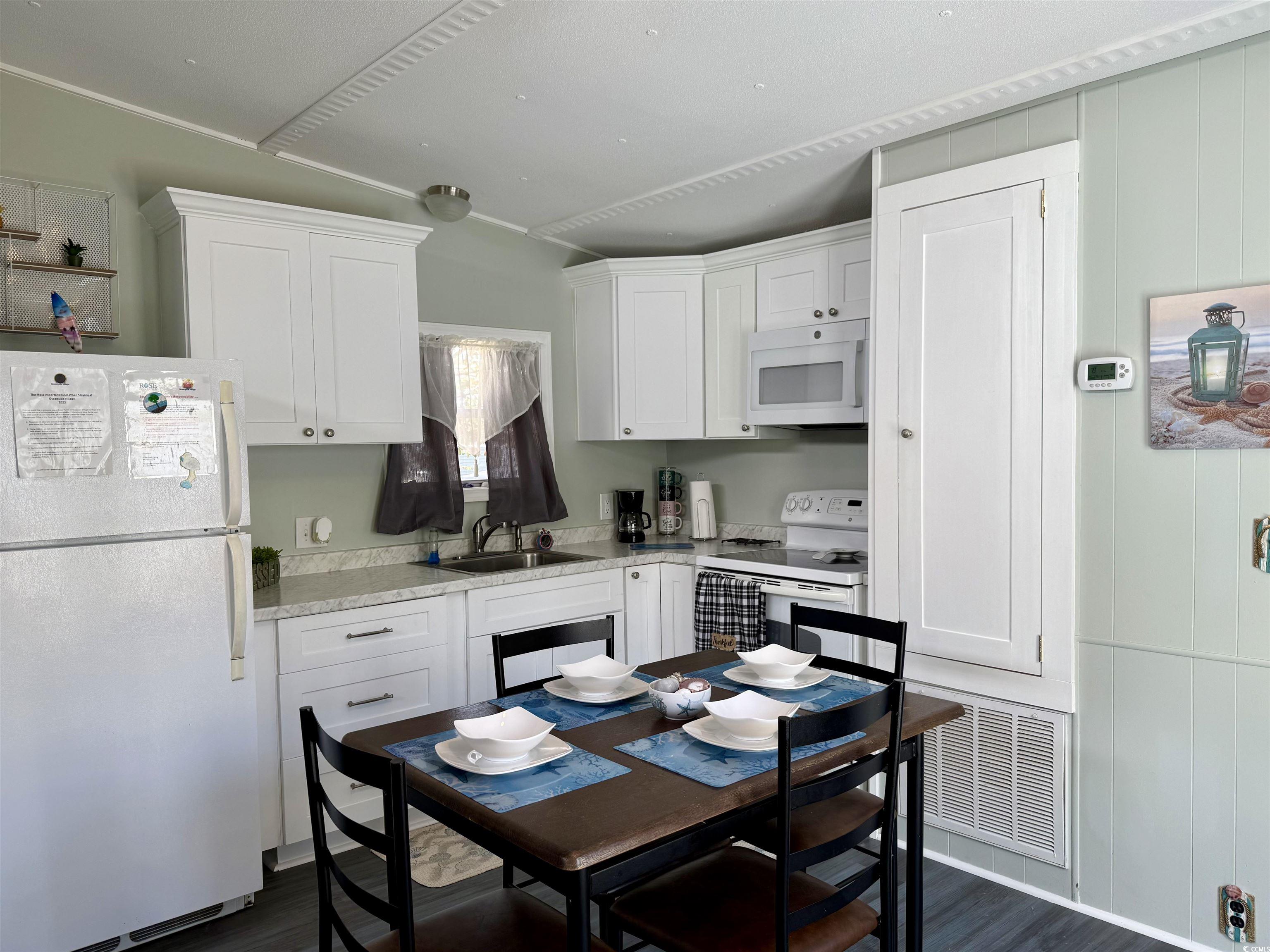 1672 Falcon Surfside Beach, SC 29575 - Photo 3 of 26 Kitchen featuring white appliances, dark wood-style floors, and white cabinetry