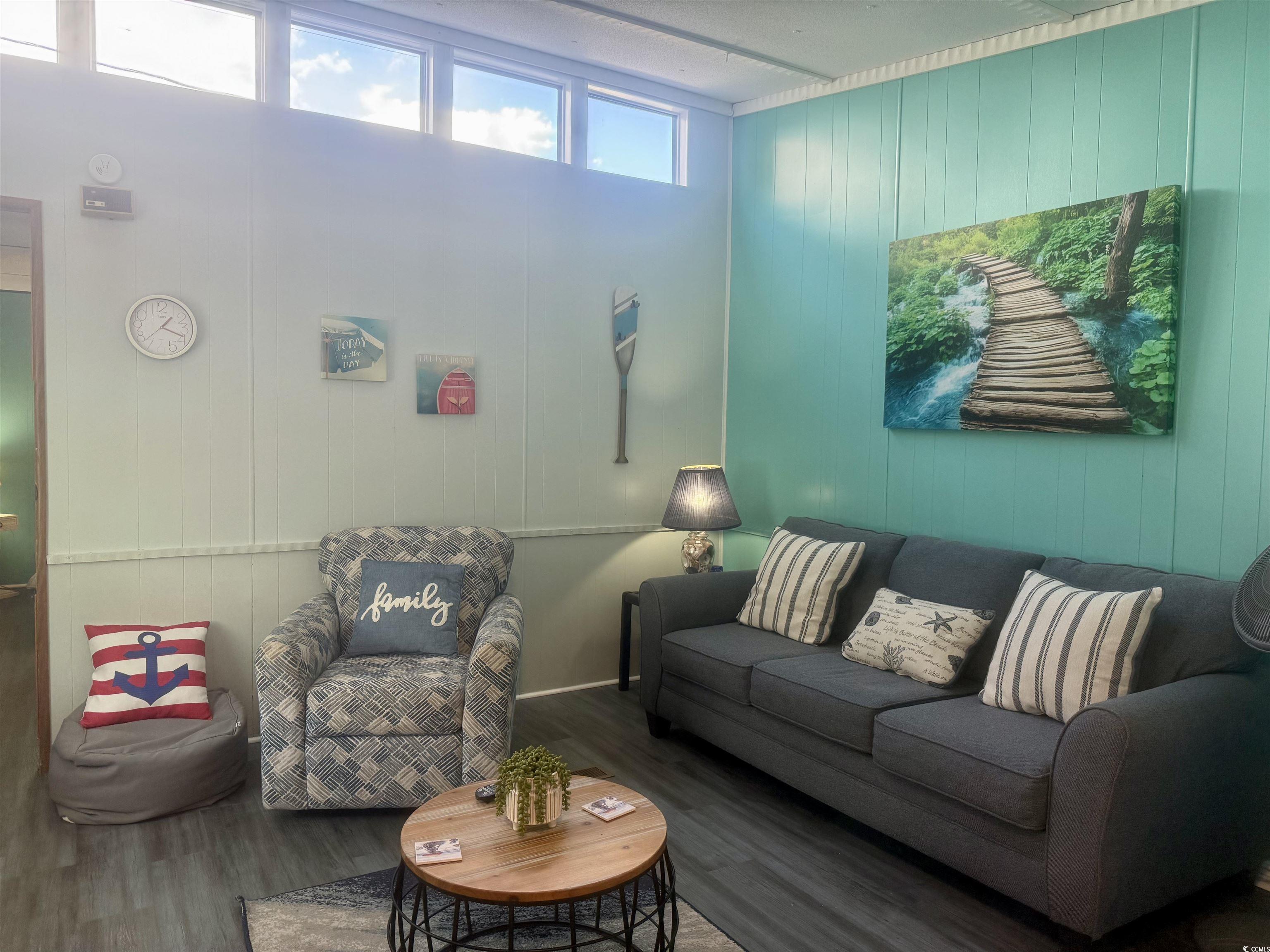 1672 Falcon Surfside Beach, SC 29575 - Photo 5 of 26 Living area featuring wood walls and wood finished floors