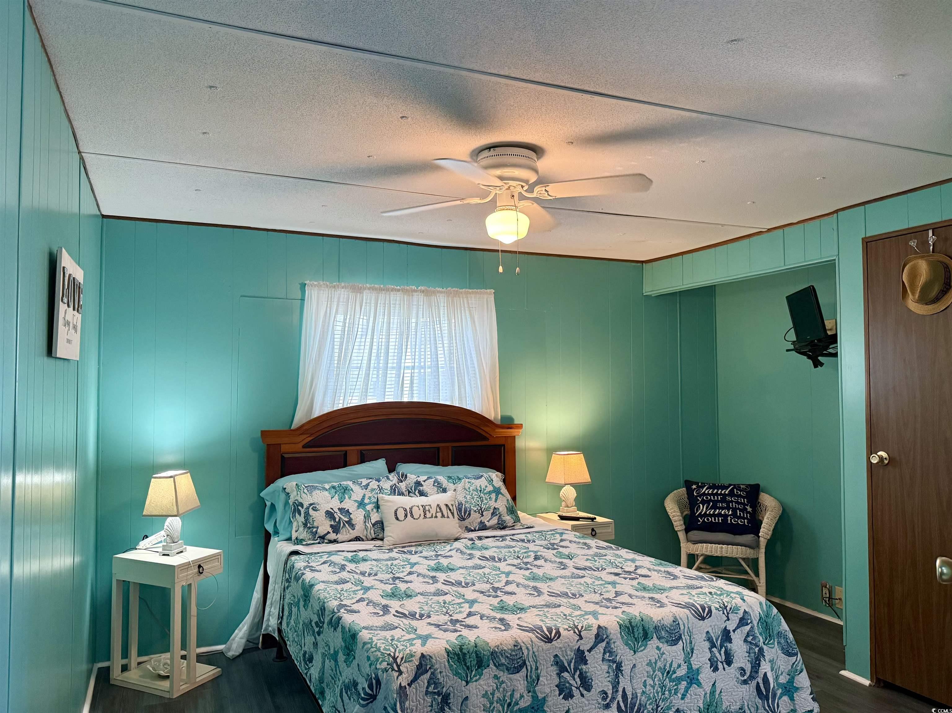 1672 Falcon Surfside Beach, SC 29575 - Photo 7 of 26 Bedroom with wood finished floors, a textured ceiling, and ceiling fan
