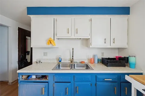 a kitchen with stainless steel appliances granite countertop a sink a stove and cabinets