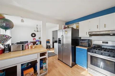 a kitchen with stainless steel appliances a stove a refrigerator and a counter space