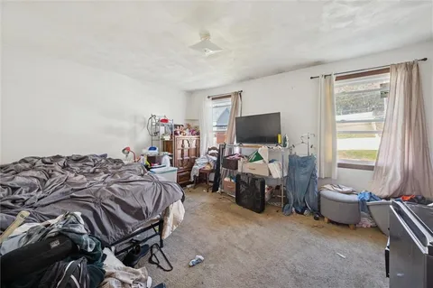 a bed room with a bed and a television