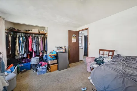 a bed room with a bed and a chair