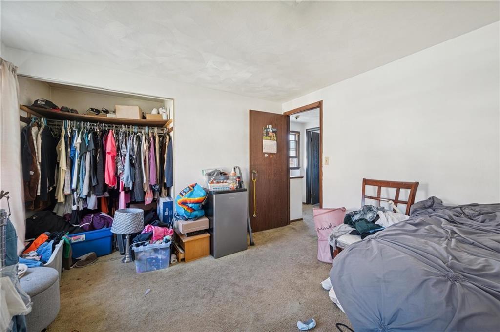 5216 Broad Street Pittsburgh, PA 15224 - Photo 17 of 32 a bed room with a bed and a chair