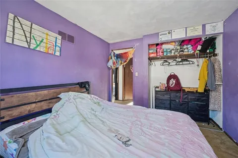 a bedroom with a bed and a dresser