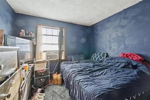 a bed sitting in a bedroom next to a window