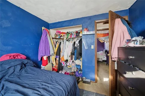 a bed room with a bed and a walk in closet