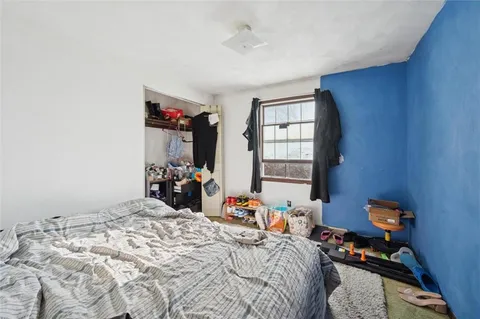 a bedroom with bed and a window