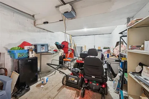 a room with gym equipment and wooden floor