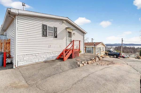 a view of a house with large space and a car park view
