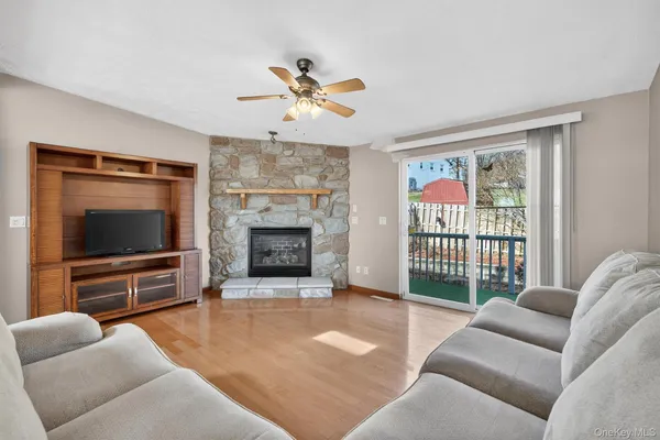 a living room with furniture tv and a window