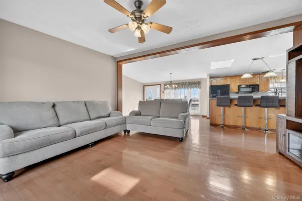 a living room with furniture and a view of kitchen