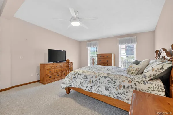 a bedroom with a bed and flat screen tv
