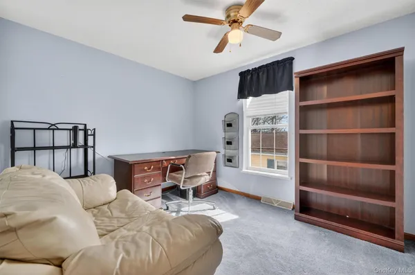a bedroom with furniture and a window