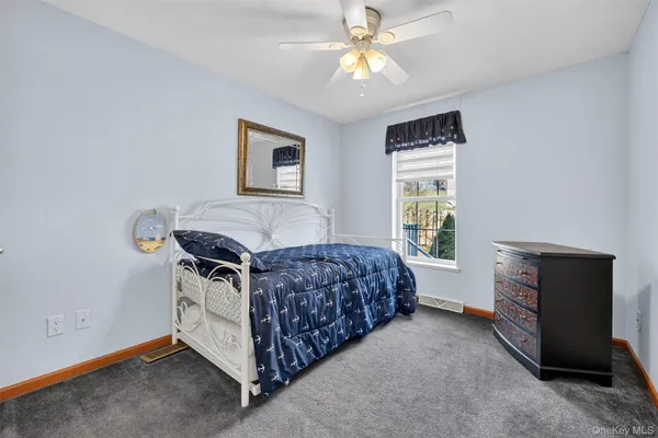 a bedroom with a bed and a ceiling fan
