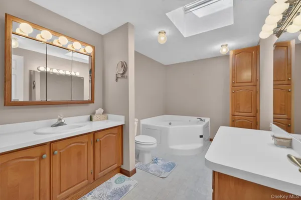 a spacious bathroom with a granite countertop sink and a mirror