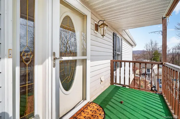 a view of a room with wooden floor and door
