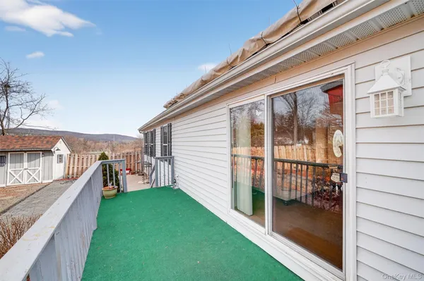 a view of a house with a yard and furniture
