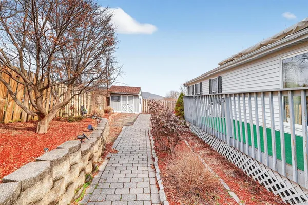 a view of a house with wooden fence