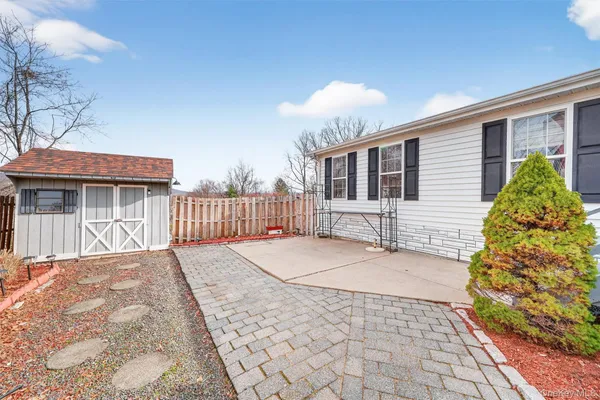 a backyard of a house with table and chairs