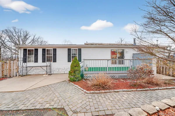 a view of a house with a small yard and sitting area