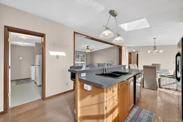a kitchen with stainless steel appliances granite countertop a sink and a stove