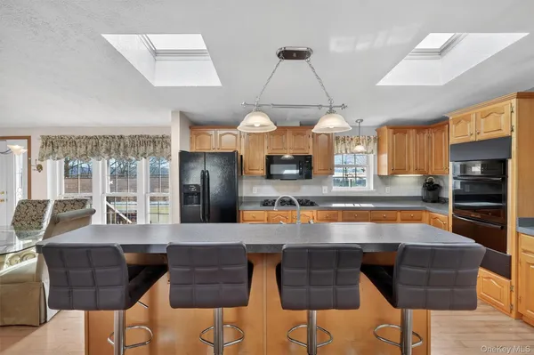 a large kitchen with a table and chairs