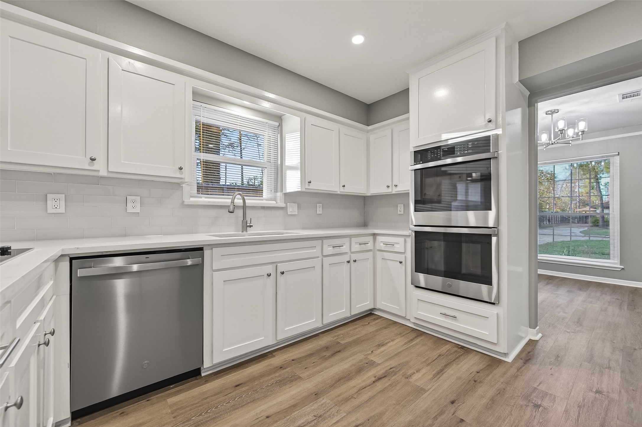 902 Kingsbridge Road Houston, TX 77073 - Photo 16 of 43 The kitchen is a bright, modern culinary space featuring crisp white cabinetry accented by sleek black hardware and high-end stainless steel appliances.