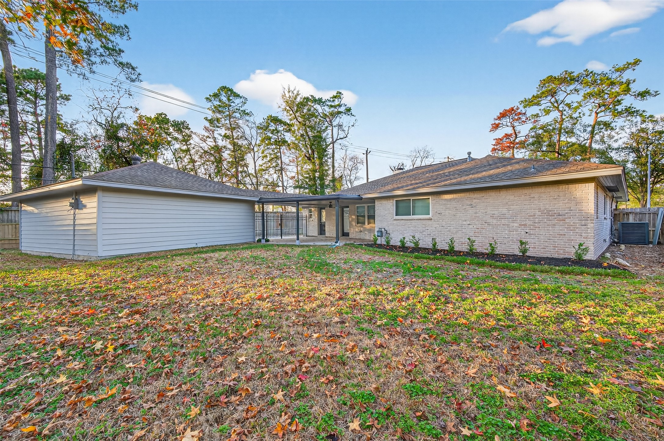 902 Kingsbridge Road Houston, TX 77073 - Photo 5 of 43 The back of the home continues the clean brick aesthetic, featuring large windows that invite natural light