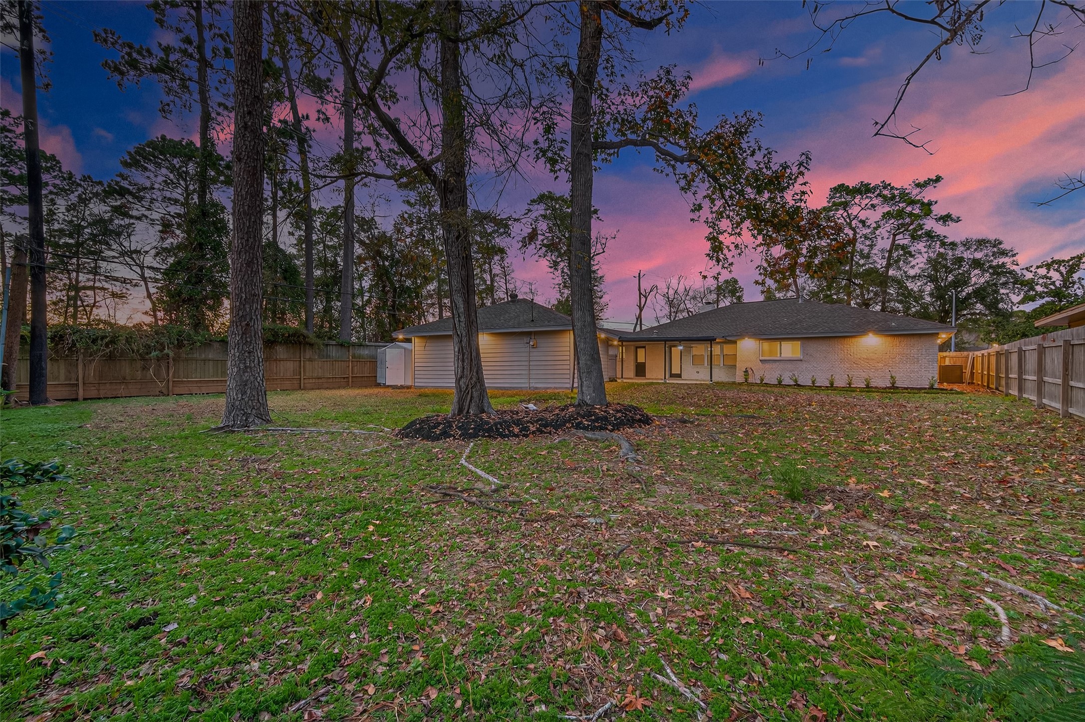 902 Kingsbridge Road Houston, TX 77073 - Photo 6 of 43 The perimeter is secured by a sturdy wooden privacy fence, making it an ideal space for pets or play.