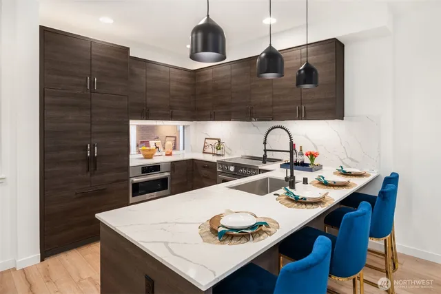 a kitchen with a sink a stove and chairs