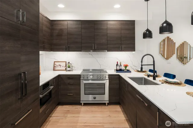 a kitchen with stainless steel appliances a sink and a stove