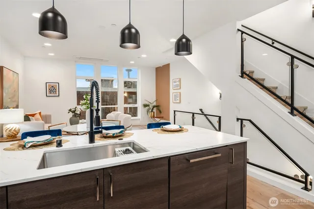 a kitchen with a sink a counter space appliances and cabinets
