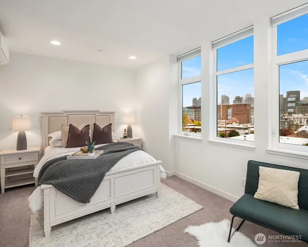 a bedroom with a bed and a chair