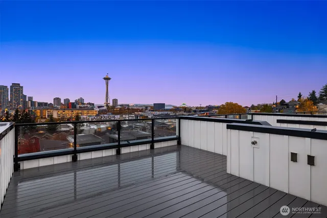a view of a balcony with wooden floor and city view