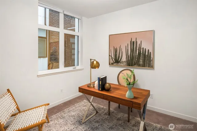 a room with a table chair and wooden floor