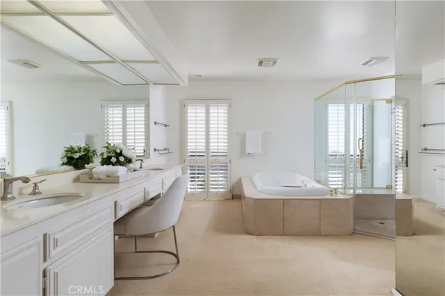 a bedroom with furniture and a large window