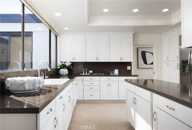 a kitchen with granite countertop a sink and cabinets