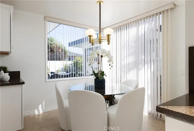 a kitchen with white cabinets and sink