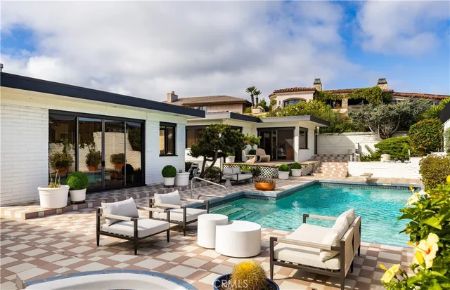 a view of a patio with dining table and chairs potted plants and a large tree