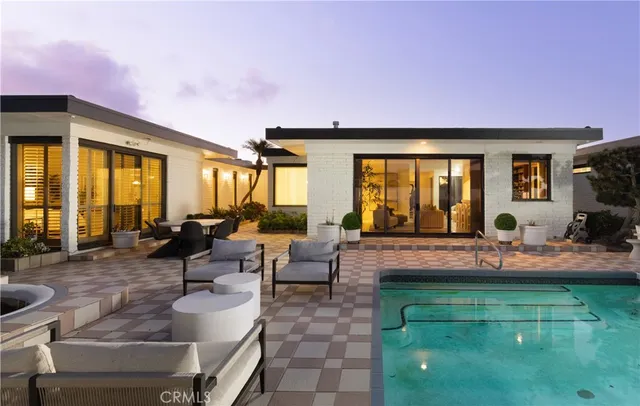 a front view of a house with swimming pool garden and patio