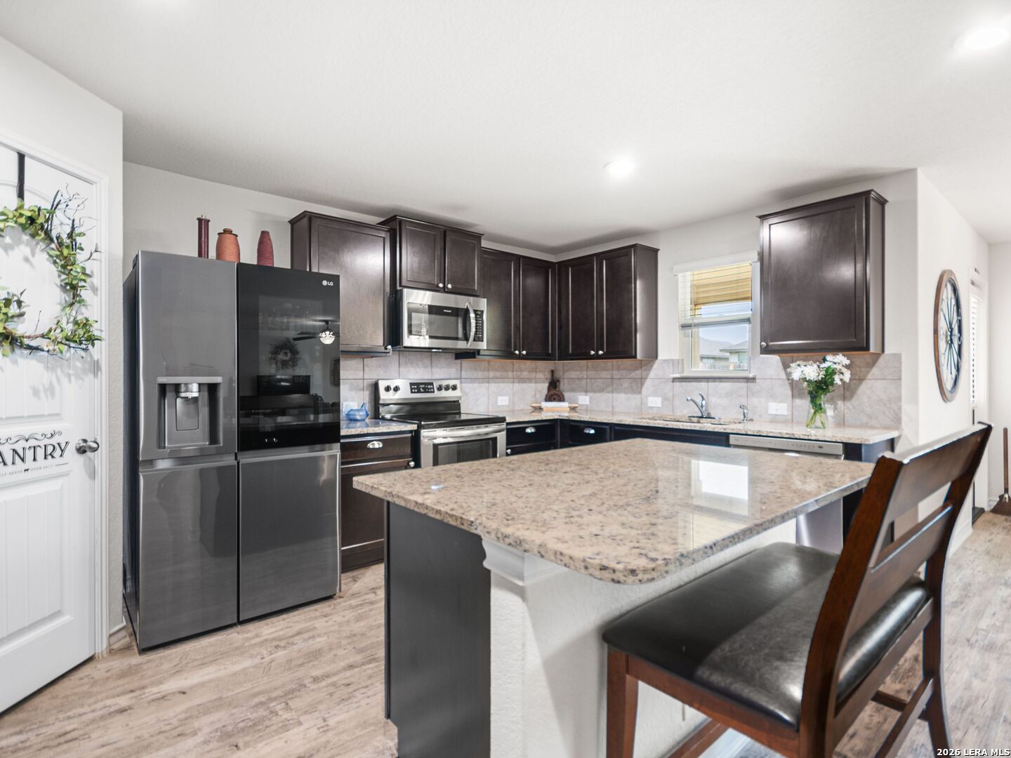 432 Salt Fork Cibolo, TX 78108 - Photo 8 of 19 a kitchen with kitchen island granite countertop a sink counter top space appliances and cabinets